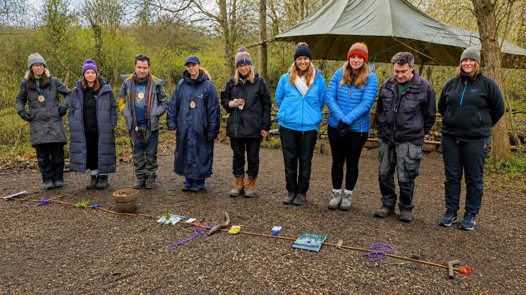 A Forest School leader training group standing together at the woodland training site
