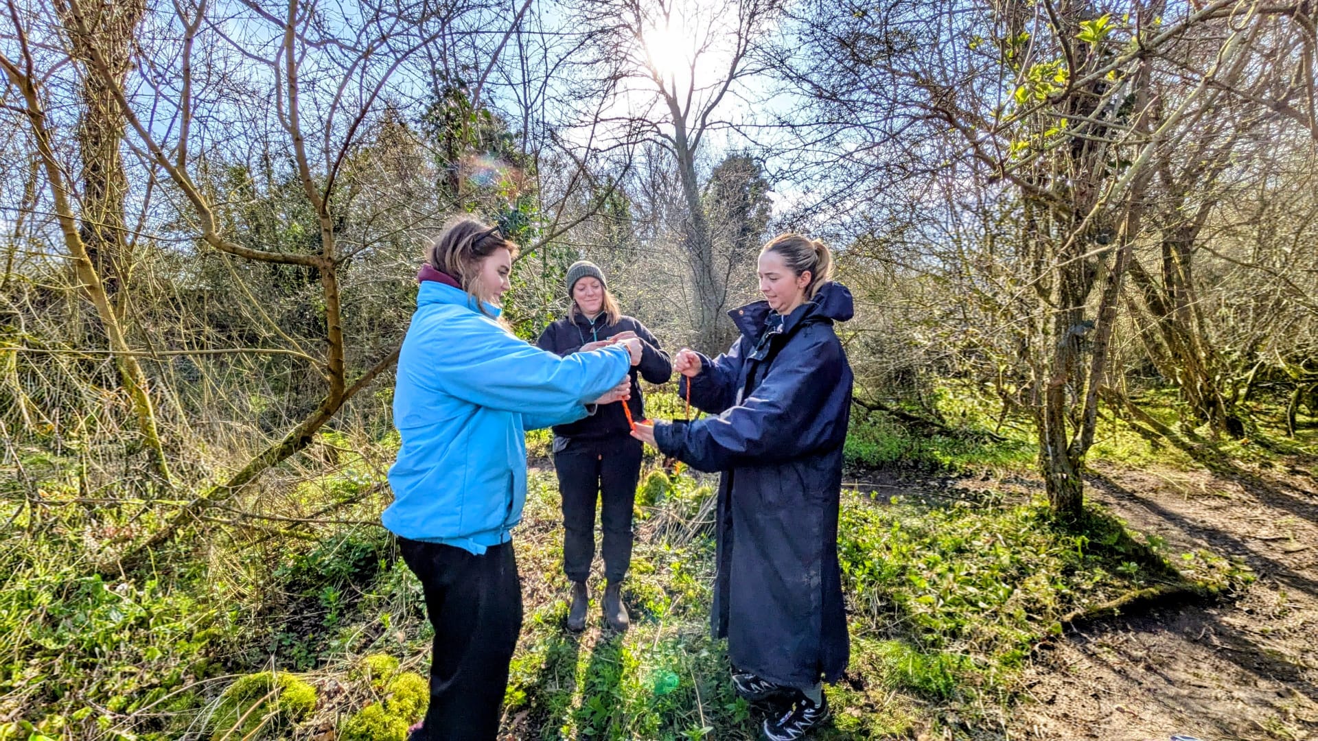 Trainees practising practical Forest School skills together in the woodland